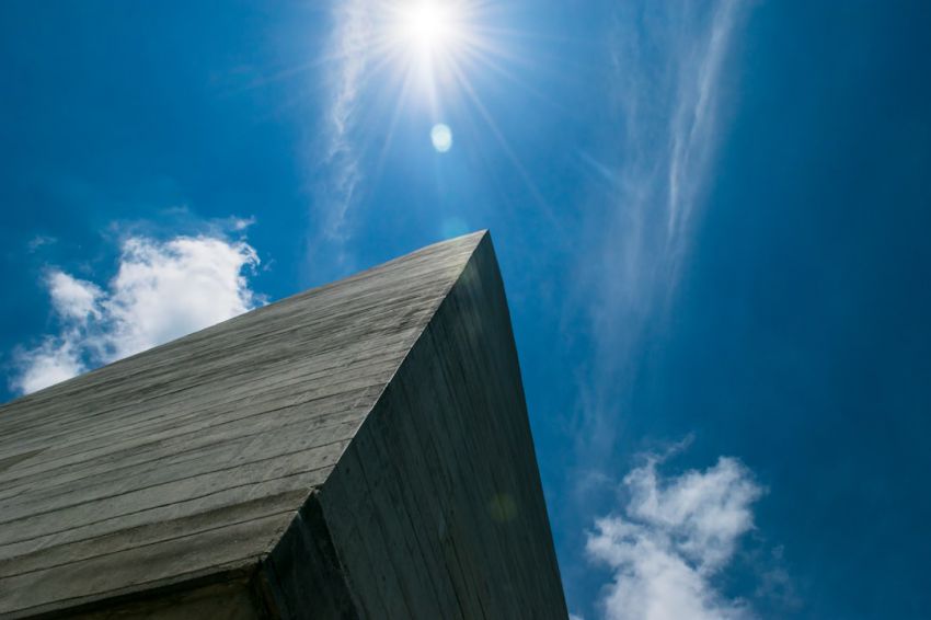 Confederacy - low angle photography of gray concrete building under blue sky during daytime
