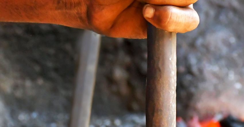 Blacksmithing - Close up on Blacksmiths Hand and Hot Metal